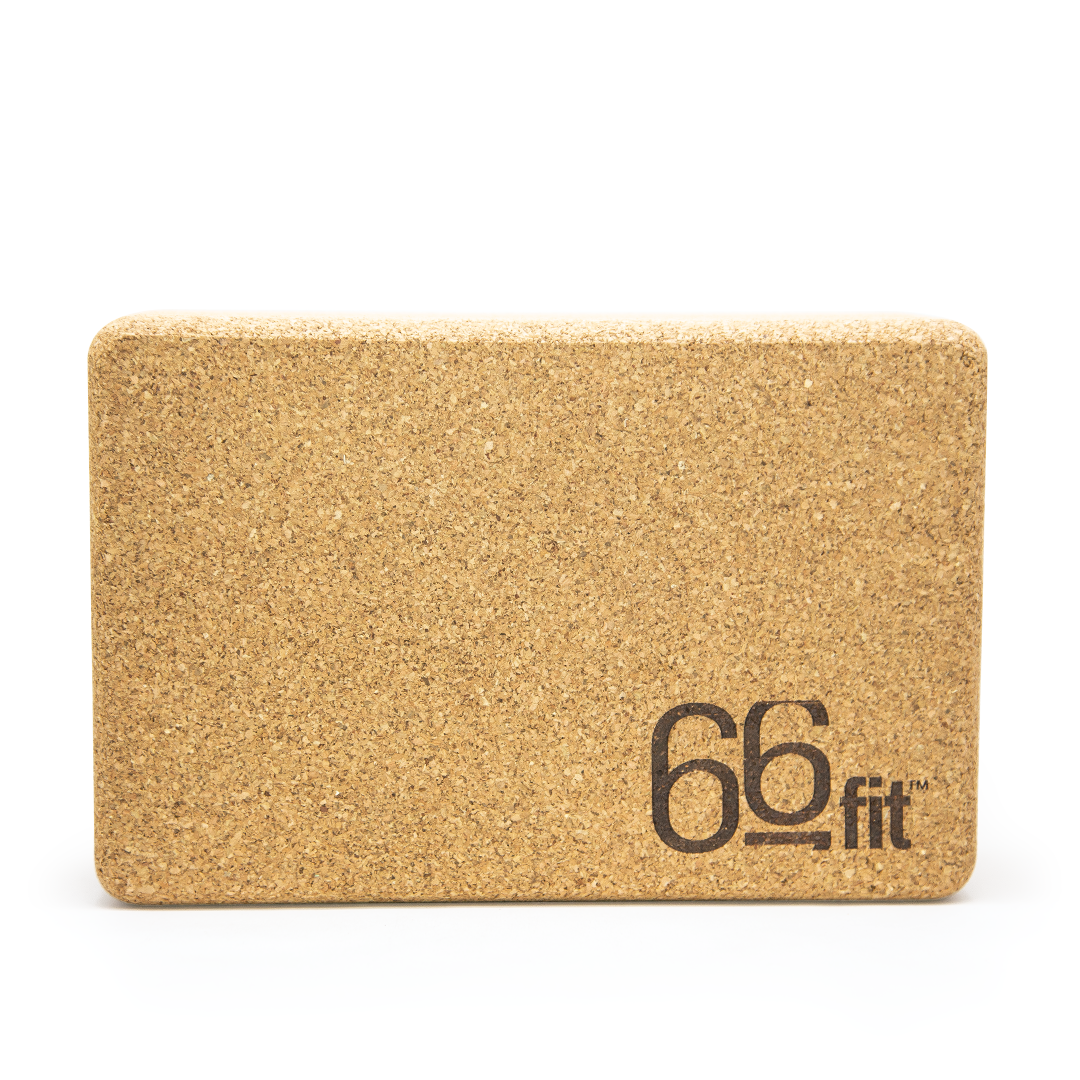 Rectangular natural cork yoga block shown on a plain background