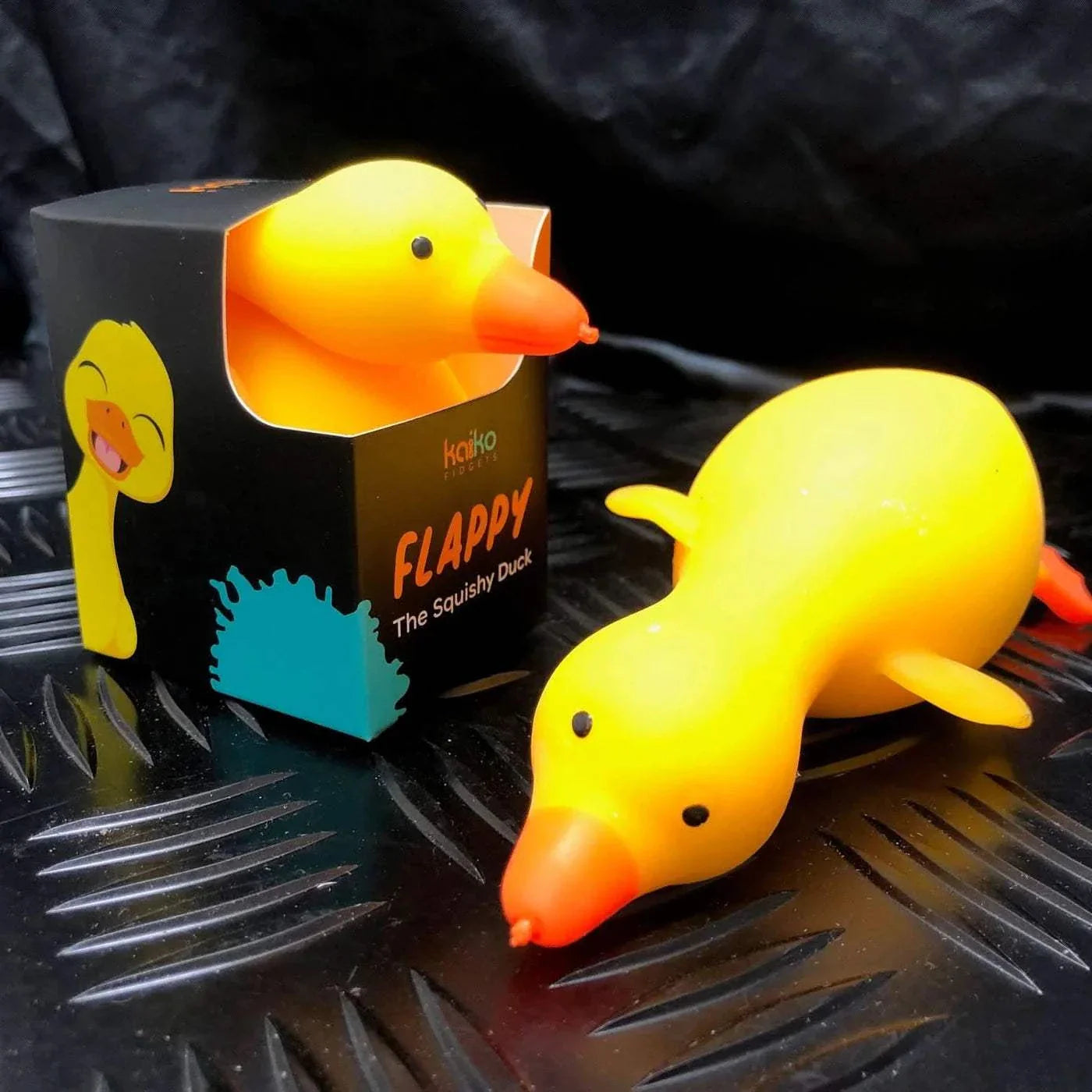 Flappy the Squishy Duck soft yellow foam toy with flapping neck, wings, and legs in black packaging