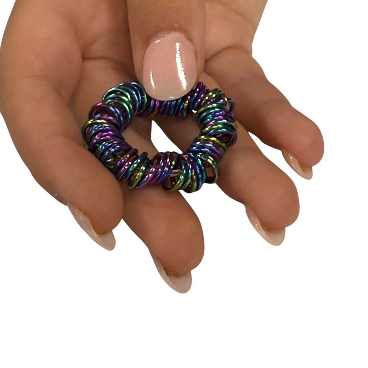 Oil slick centipede fidget laid flat, showing the rainbow colouring across the rings