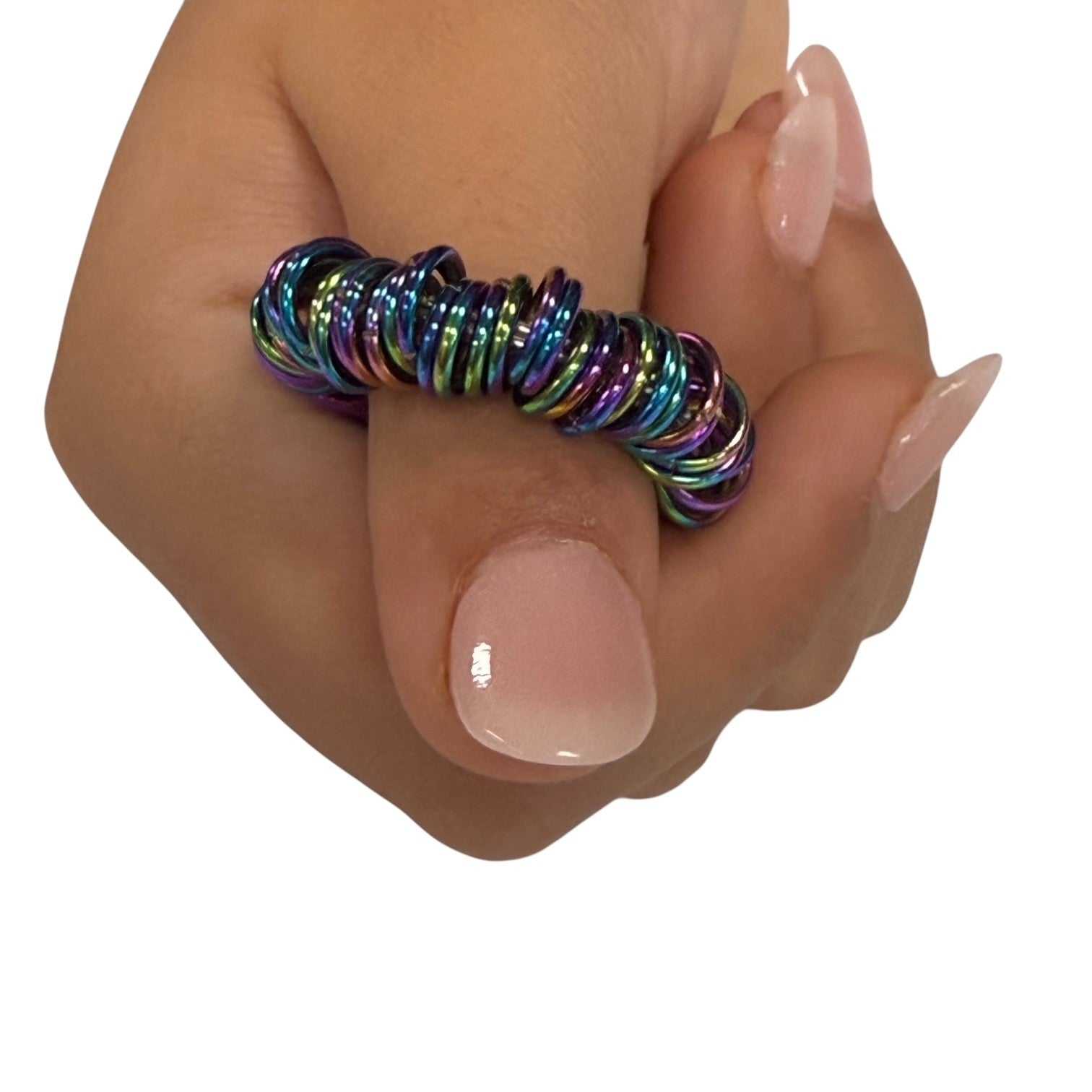 Small loop of rainbow coloured stainless steel rings held between two fingers