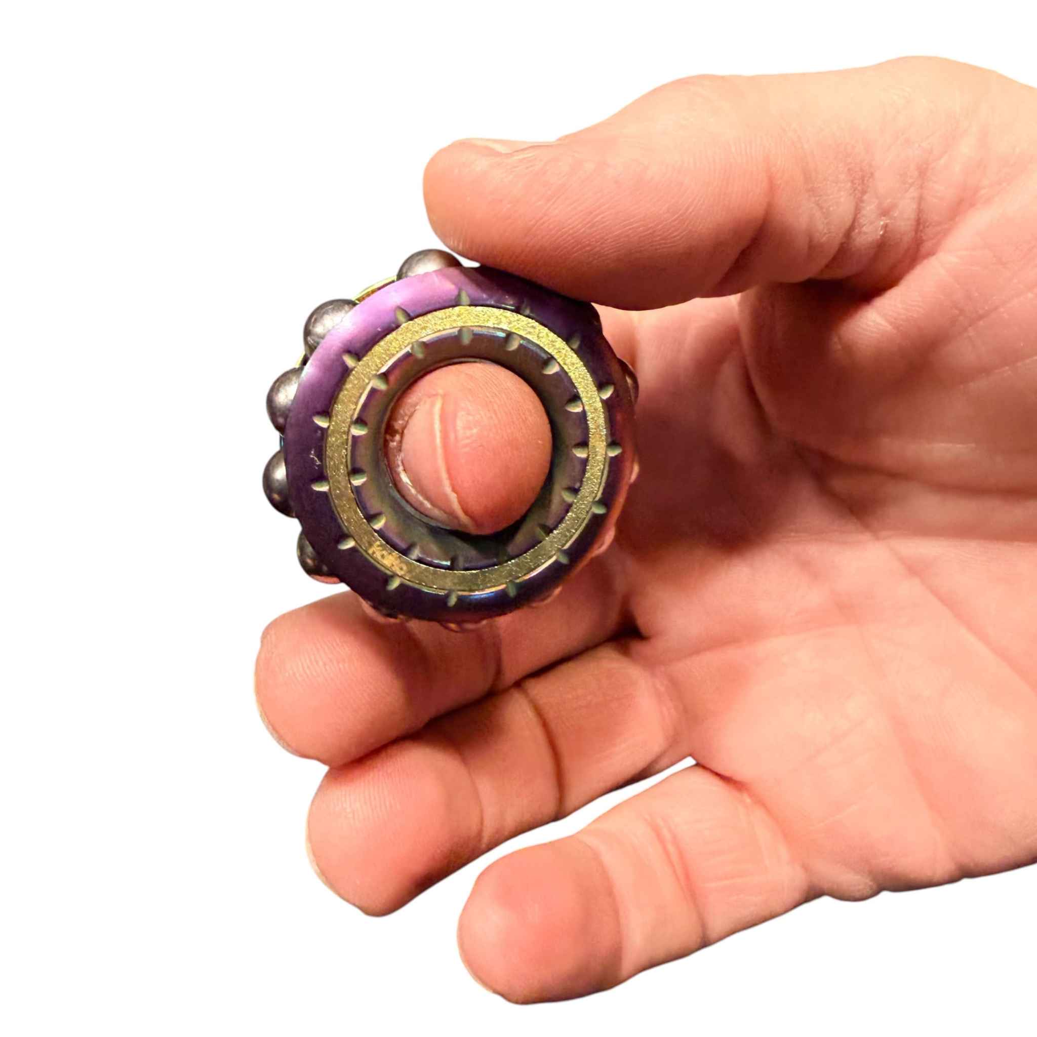 Freewheel spinner held between finger and thumb and being spun