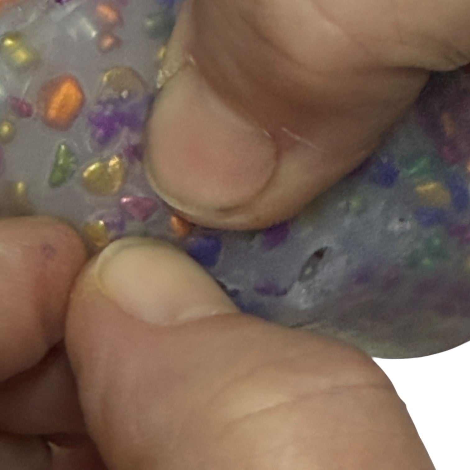 Hands picking a piece out of a silicone Pick 'Em design